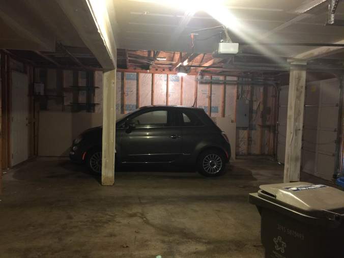 Very little car in a normal-sized garage bay.