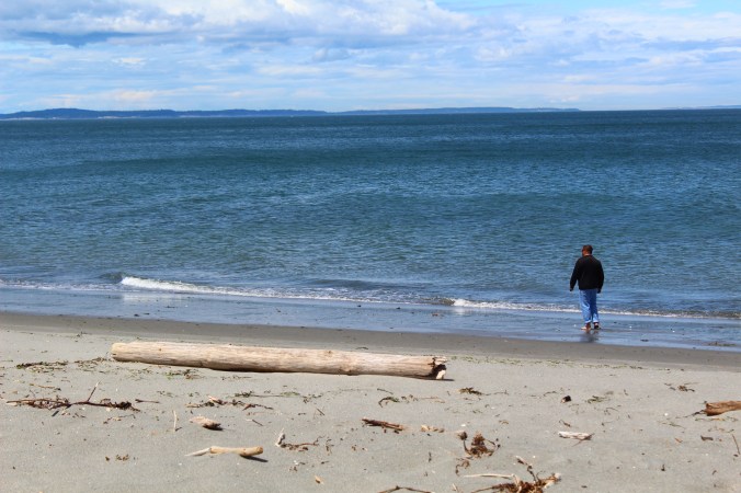 The hubby walking along the sand.